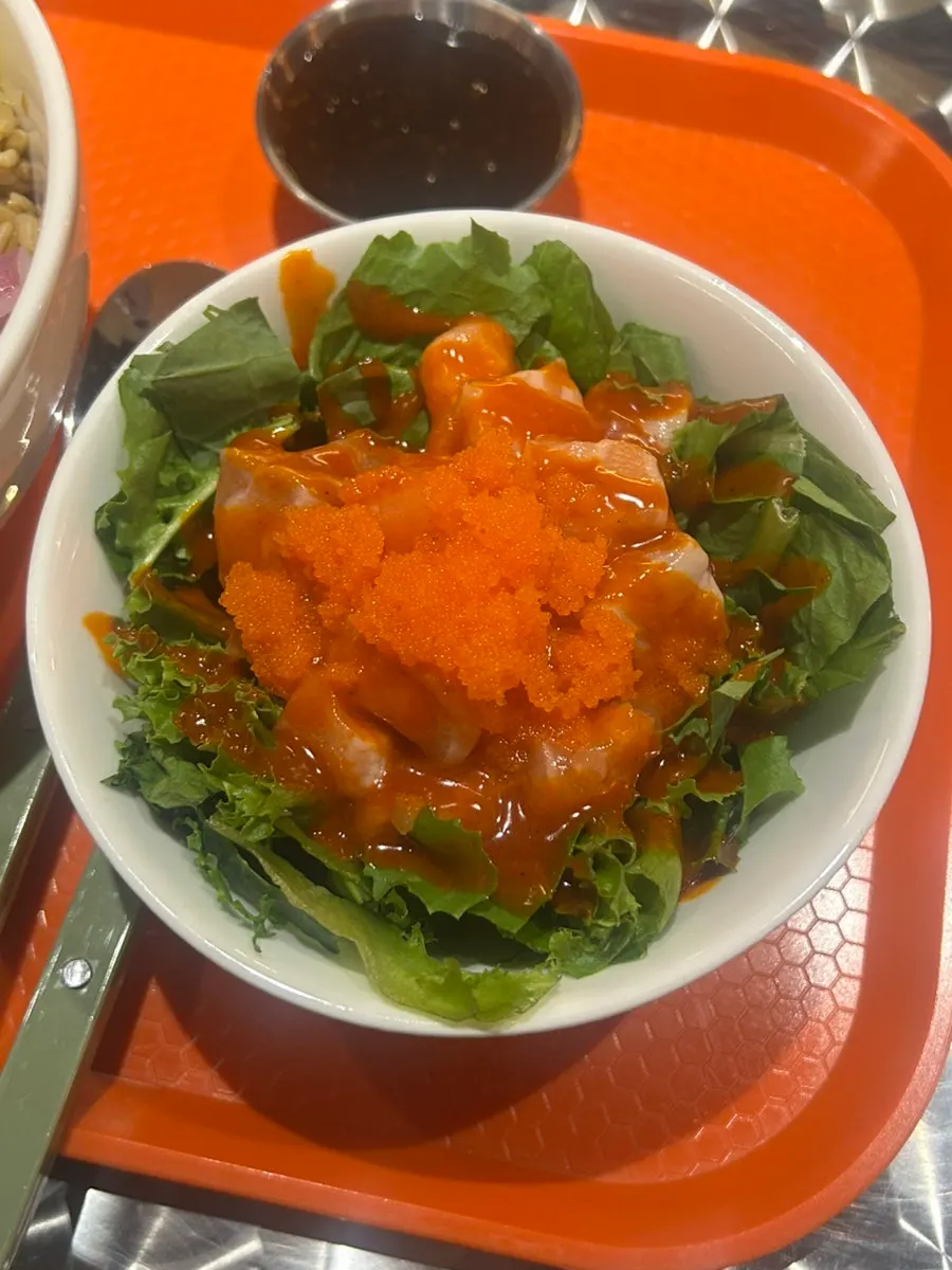 Buldak salmon kkakdugi topped with flying fish roe and buldak sauce