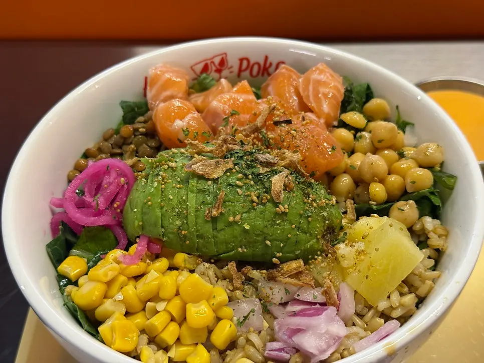 A bowl of poke with added avocado and raw salmon