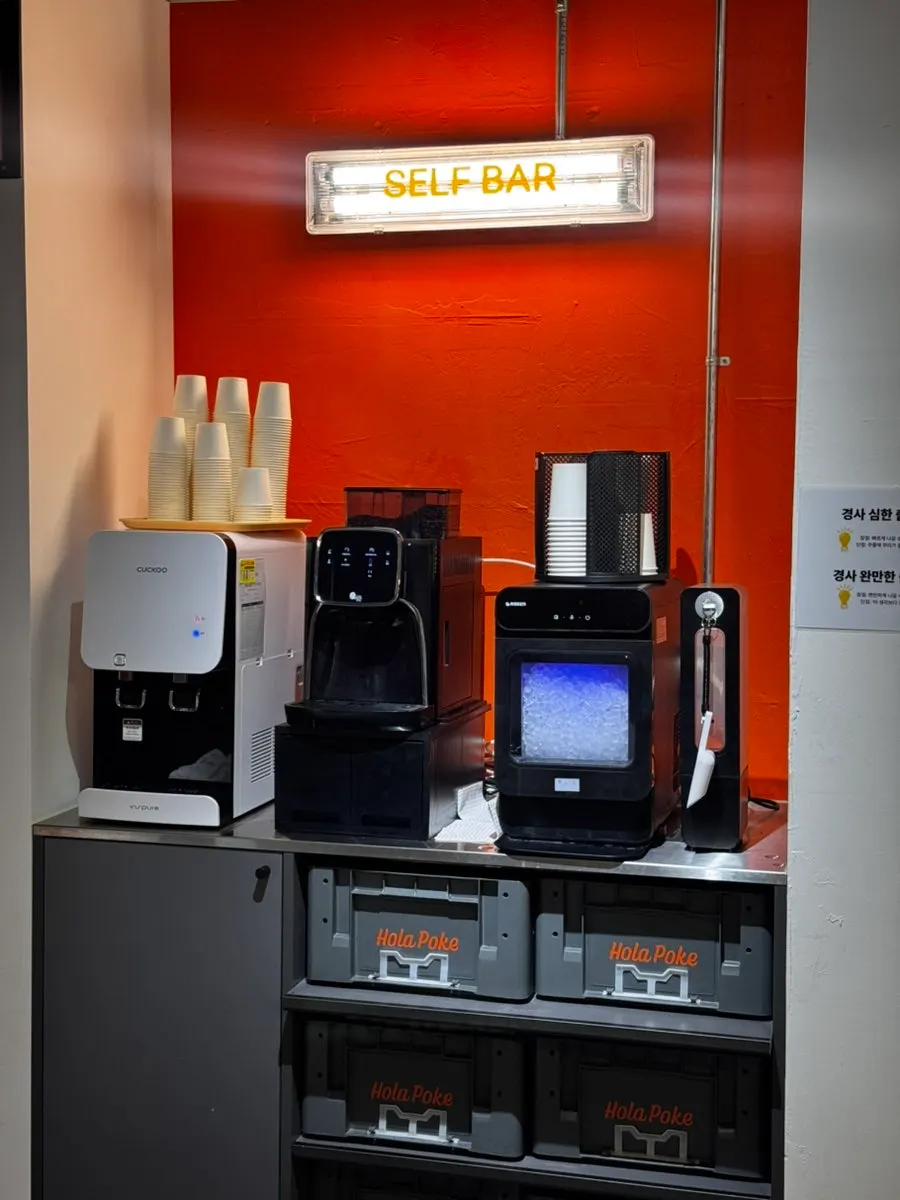 Self-serve bar with water dispenser and ice at Olla Poke