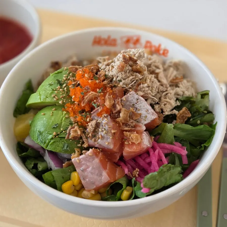 Poke bowl with salmon, chicken breast, and avocado