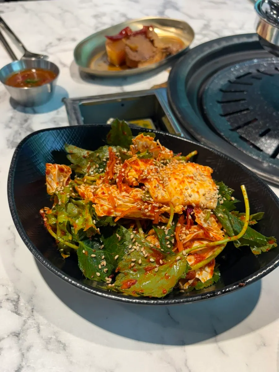 Gat kimchi, myeongi namul, and baek kimchi side dishes