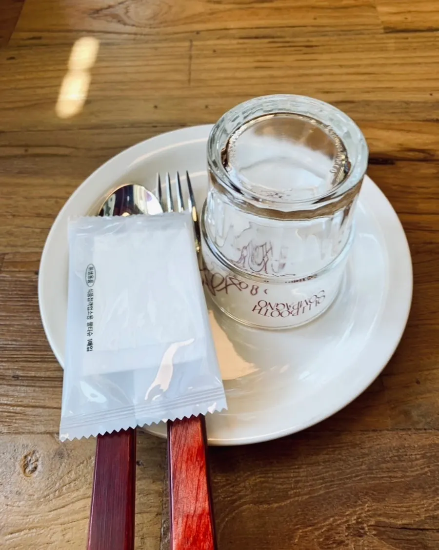Table set with utensils and a yellow water bottle