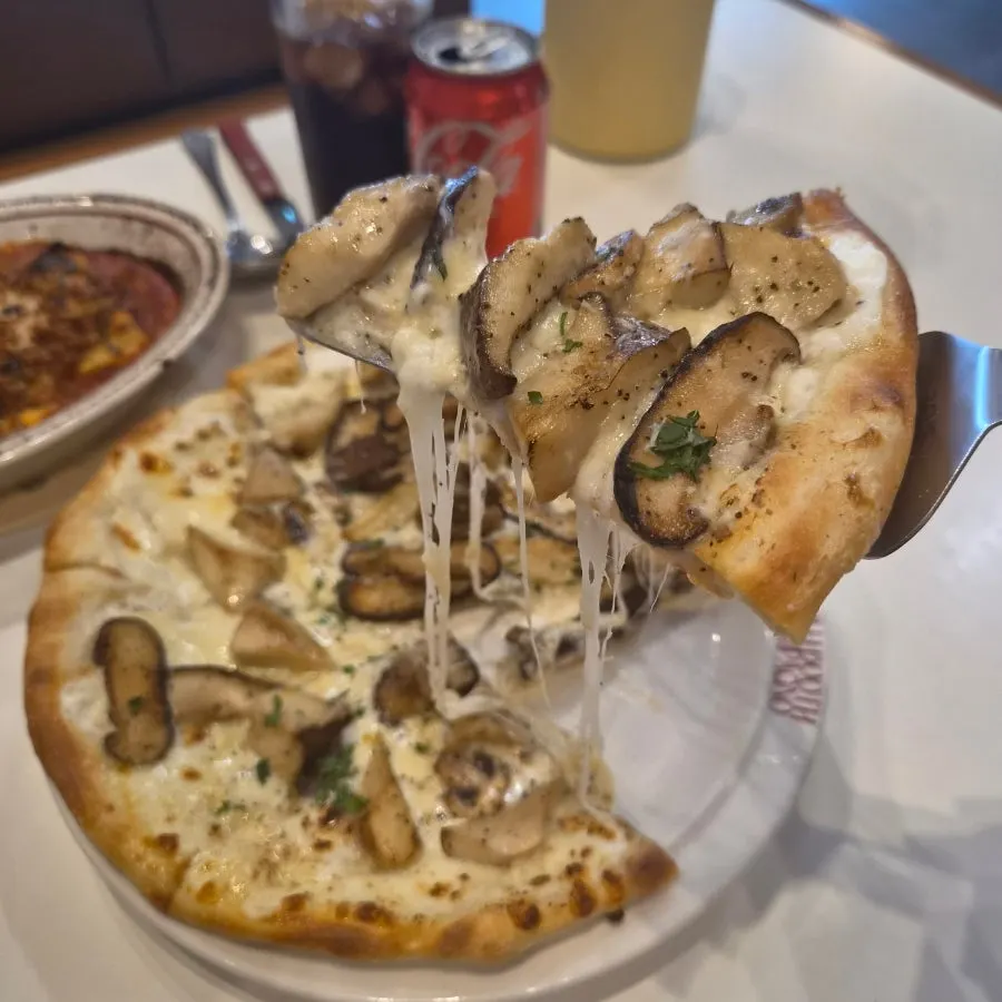 Close-up of a slice of truffle funghi pizza