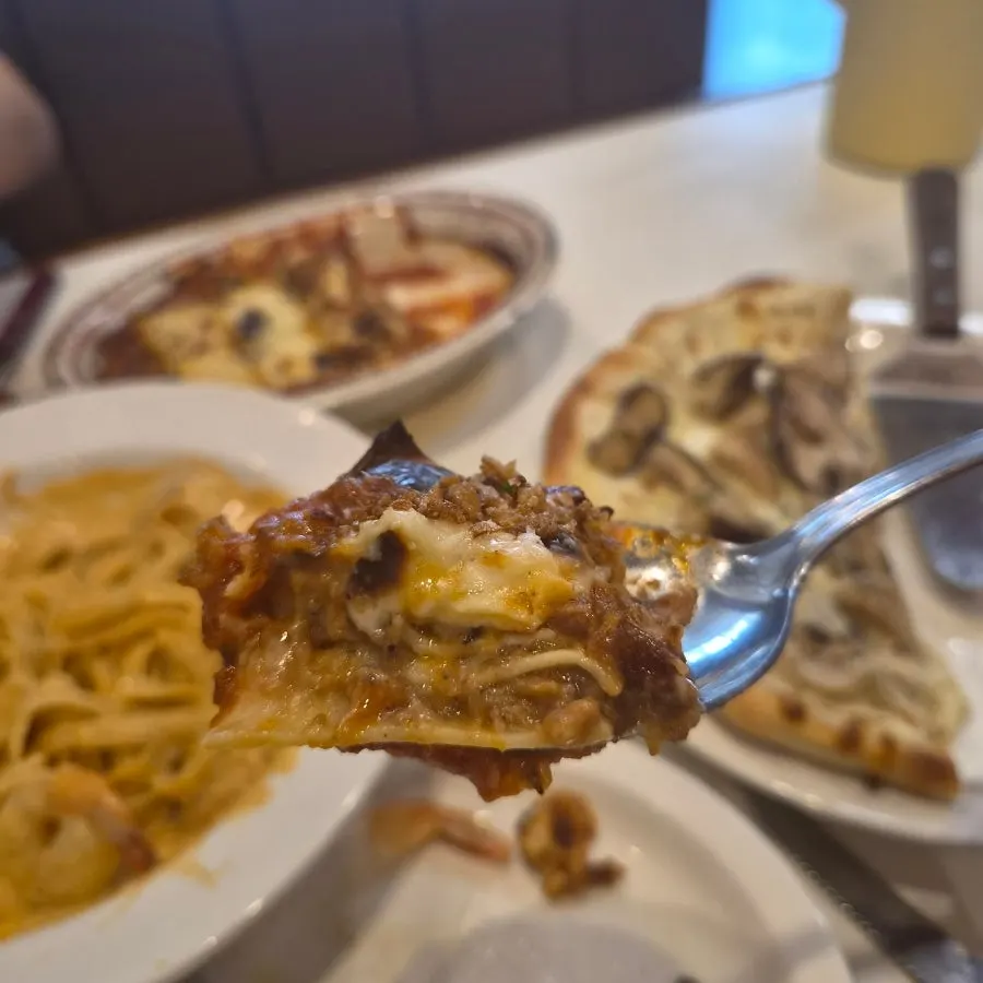 A cross-section of lasagna cut with a fork