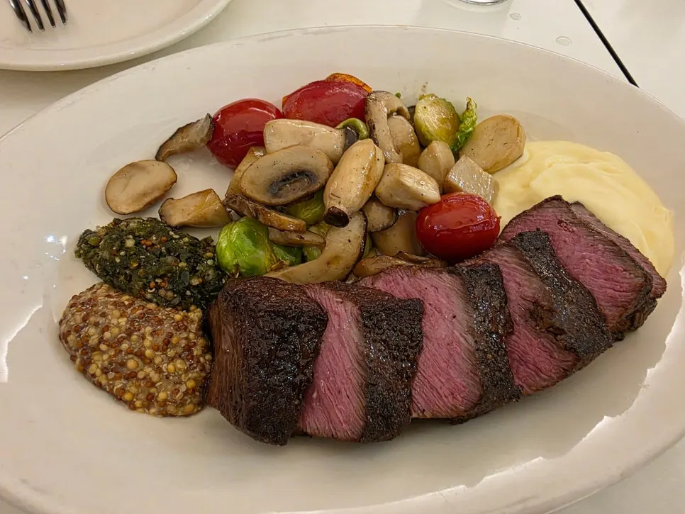 Hanger steak plating with grilled vegetables and mashed potatoes