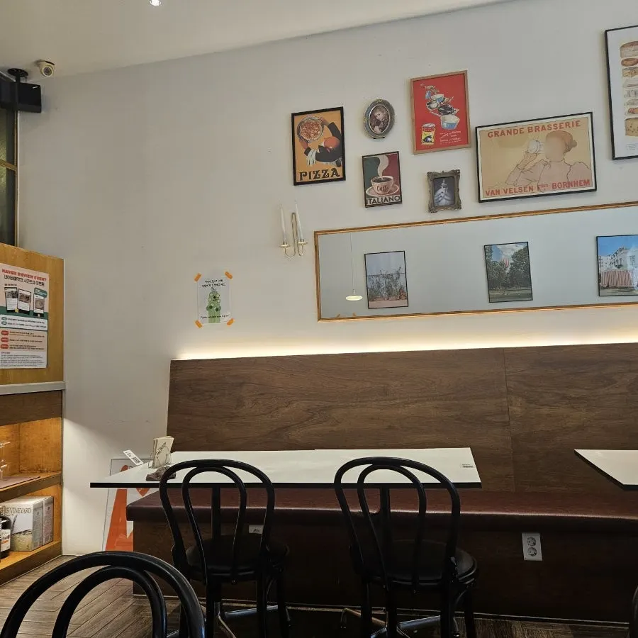 Wall with European-style posters and a table