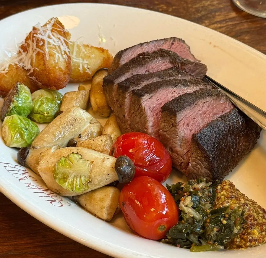 Rare-cooked steak with garnish