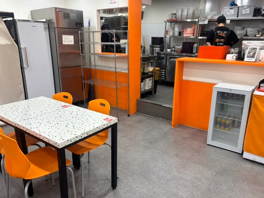 The Toss Place ordering kiosk and set menu signage