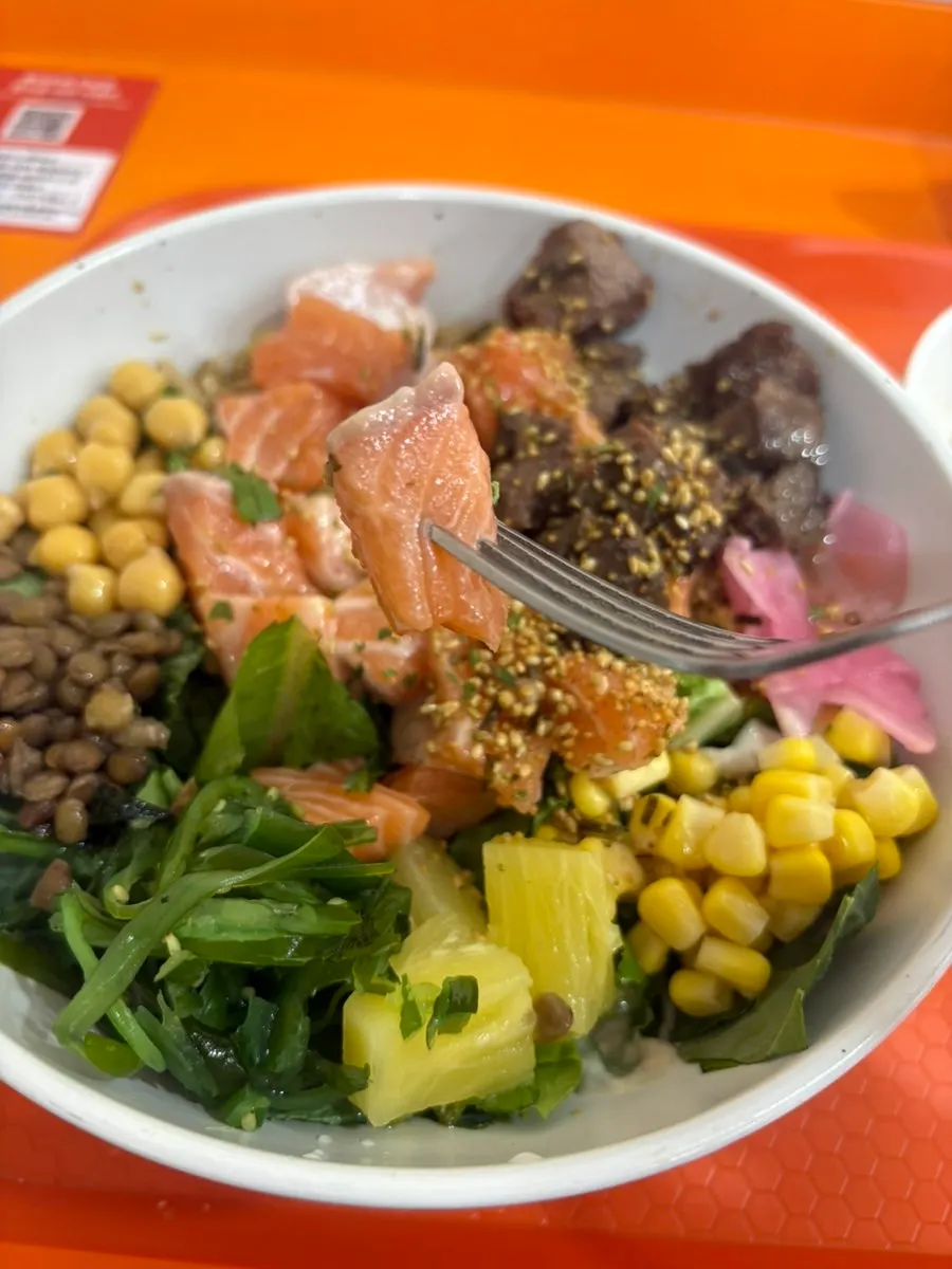 Close-up of poke topped with salmon and steak