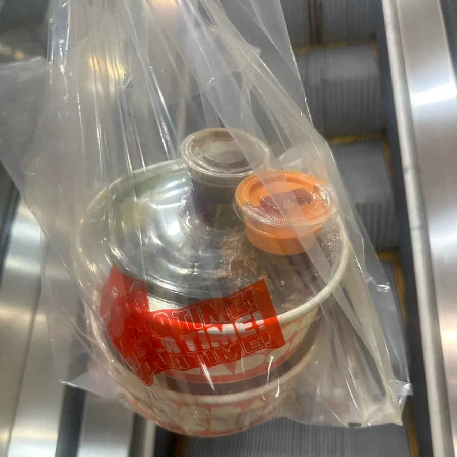 Packaged takeout bag of Olla Poke bowls