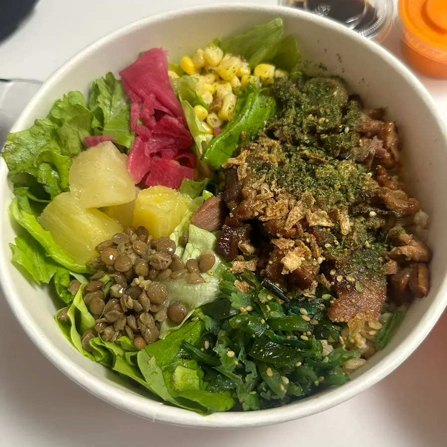 Close-up of two poke bowls packed with toppings