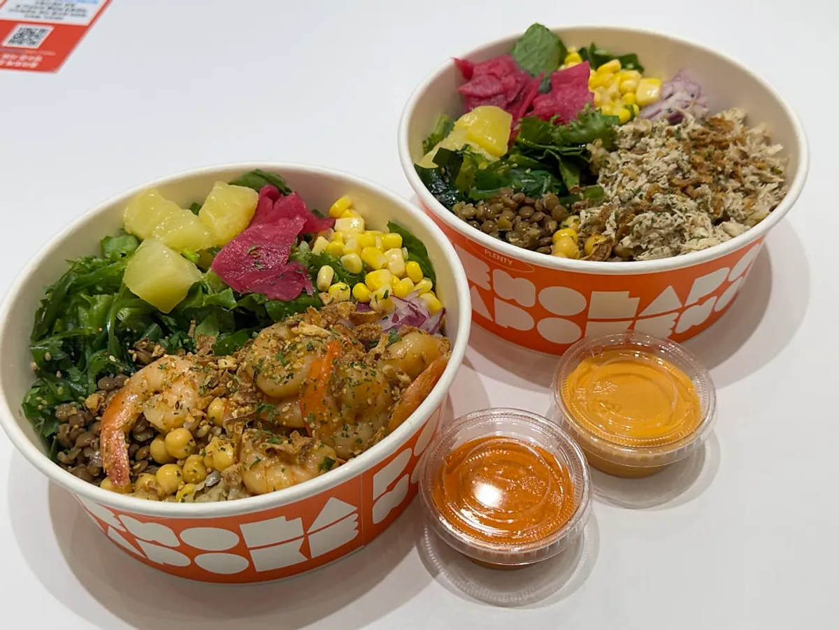 Two bowls: garlic shrimp poke and chicken breast poke