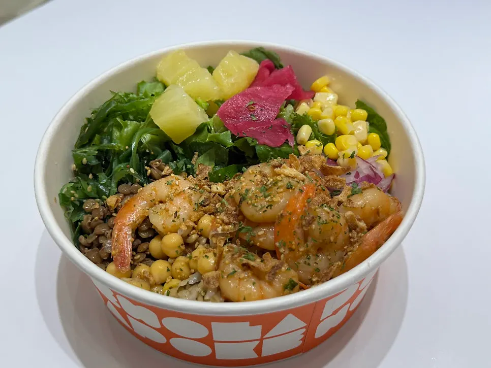 A generously filled poke bowl with 5:5 salad and brown rice ratio