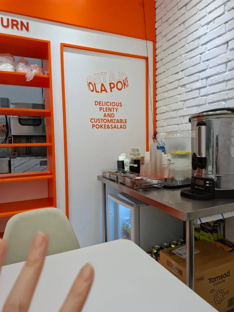 Half-open kitchen enclosed in glass at Olla Poke Munjeong Main Branch