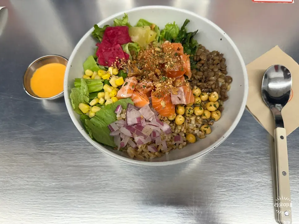 Salmon poke arranged by color over grain rice
