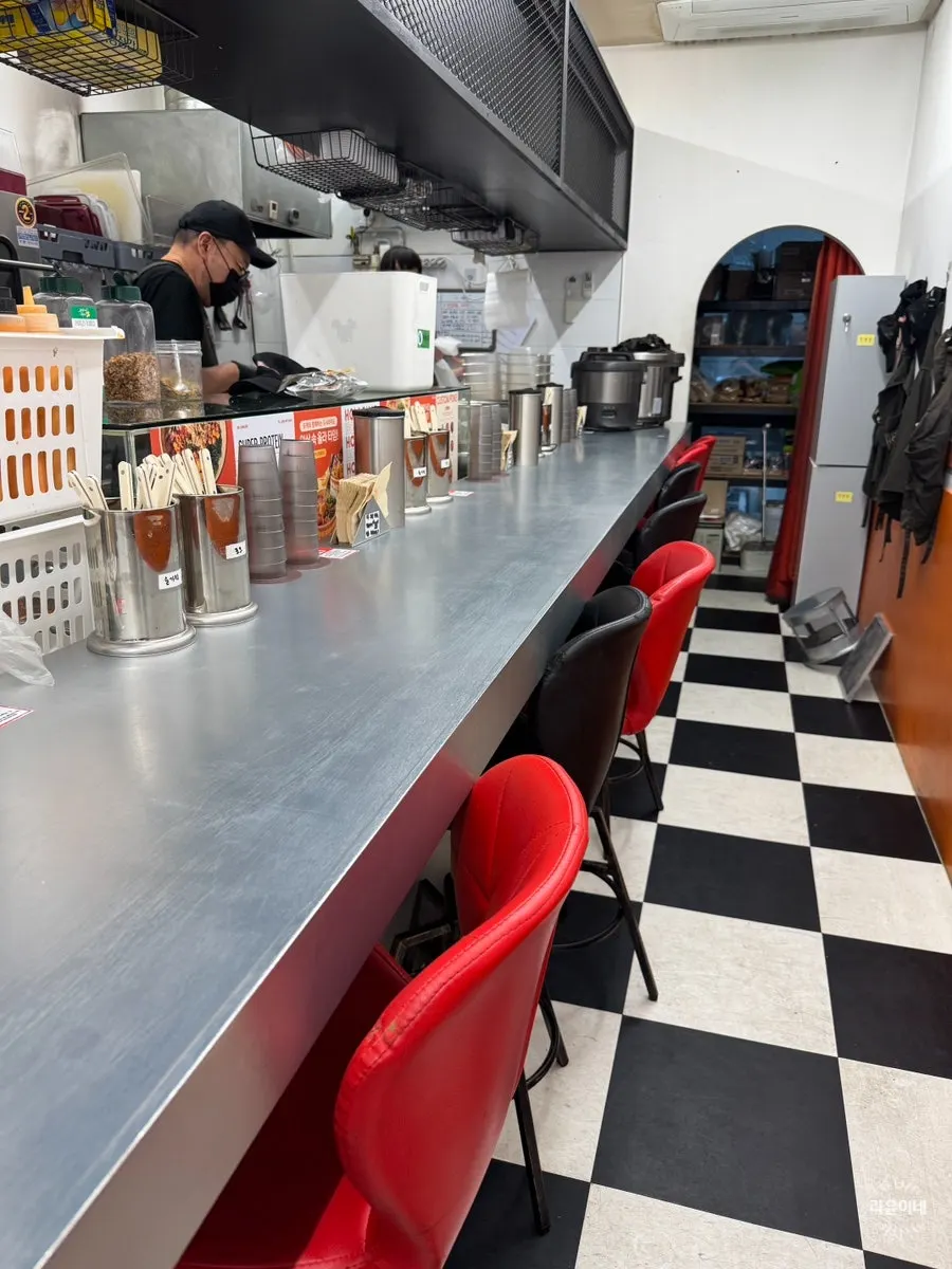 Self-service bar with paper cups, forks, and spoons