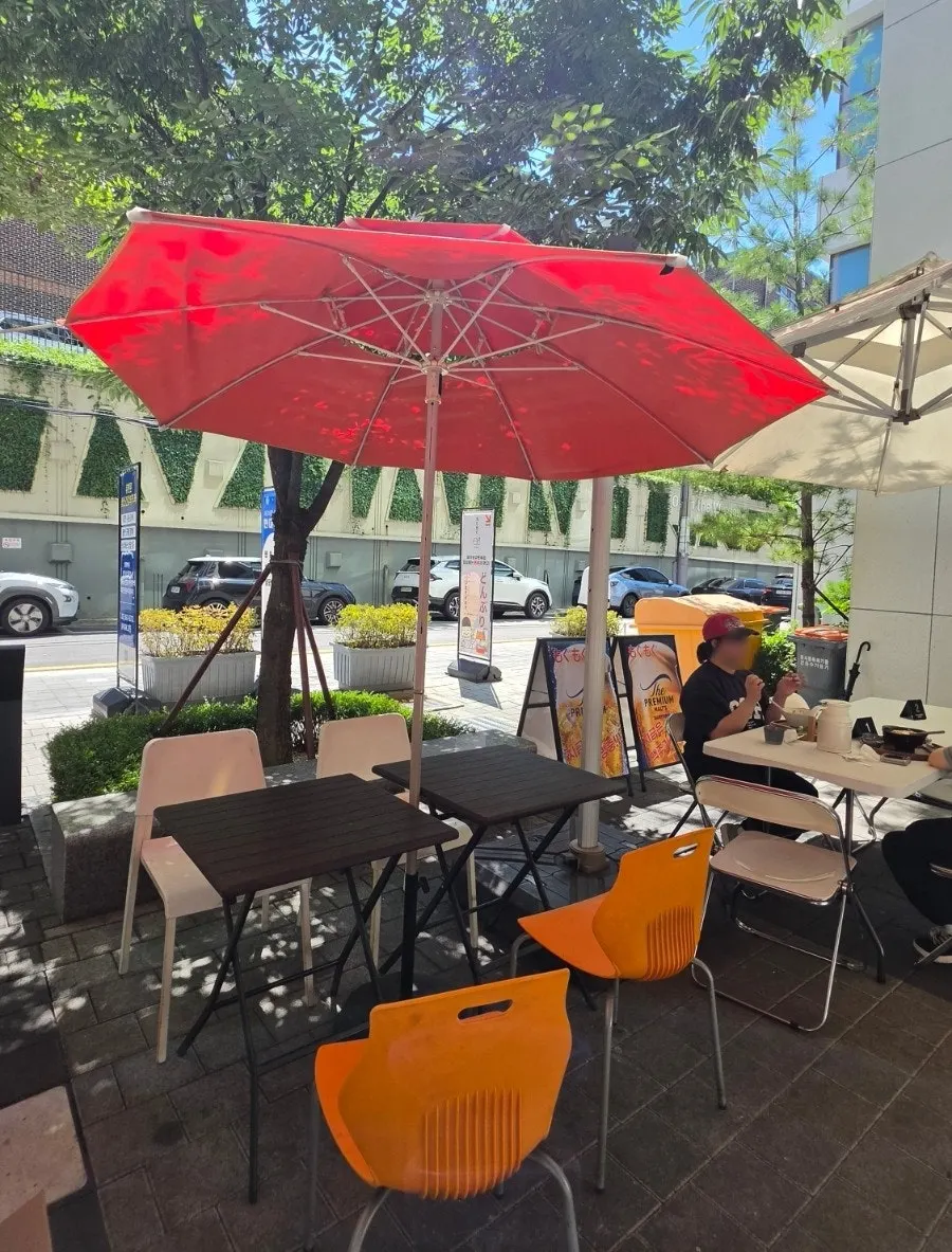 Exterior of Ola Poke Samseong Branch with its orange accents