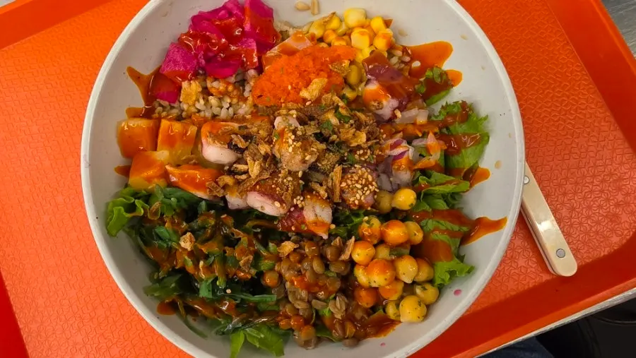 Close-up of poke toppings mixing chickpeas, corn and grains