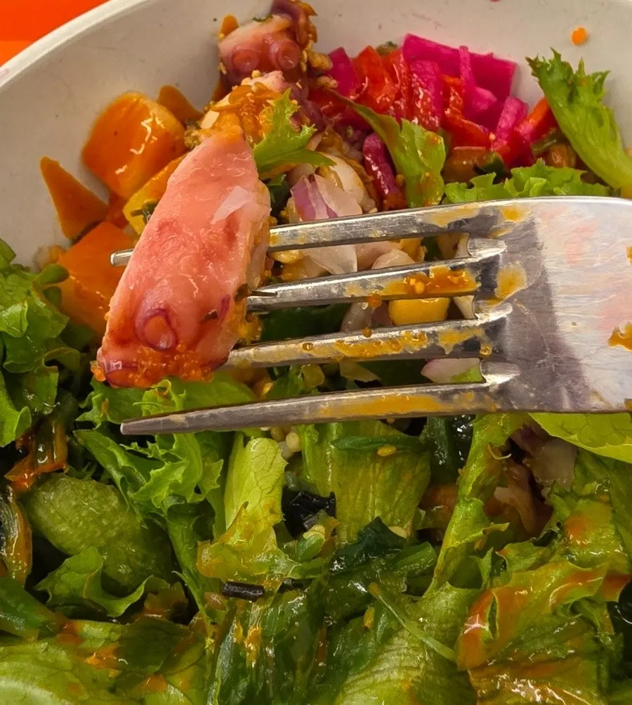 The buldak octopus poke bowl about half eaten