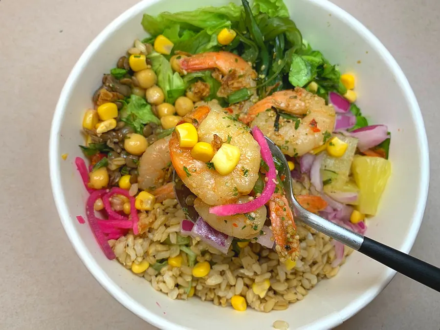 Garlic shrimp sprinkled with crushed pepper over oat brown rice