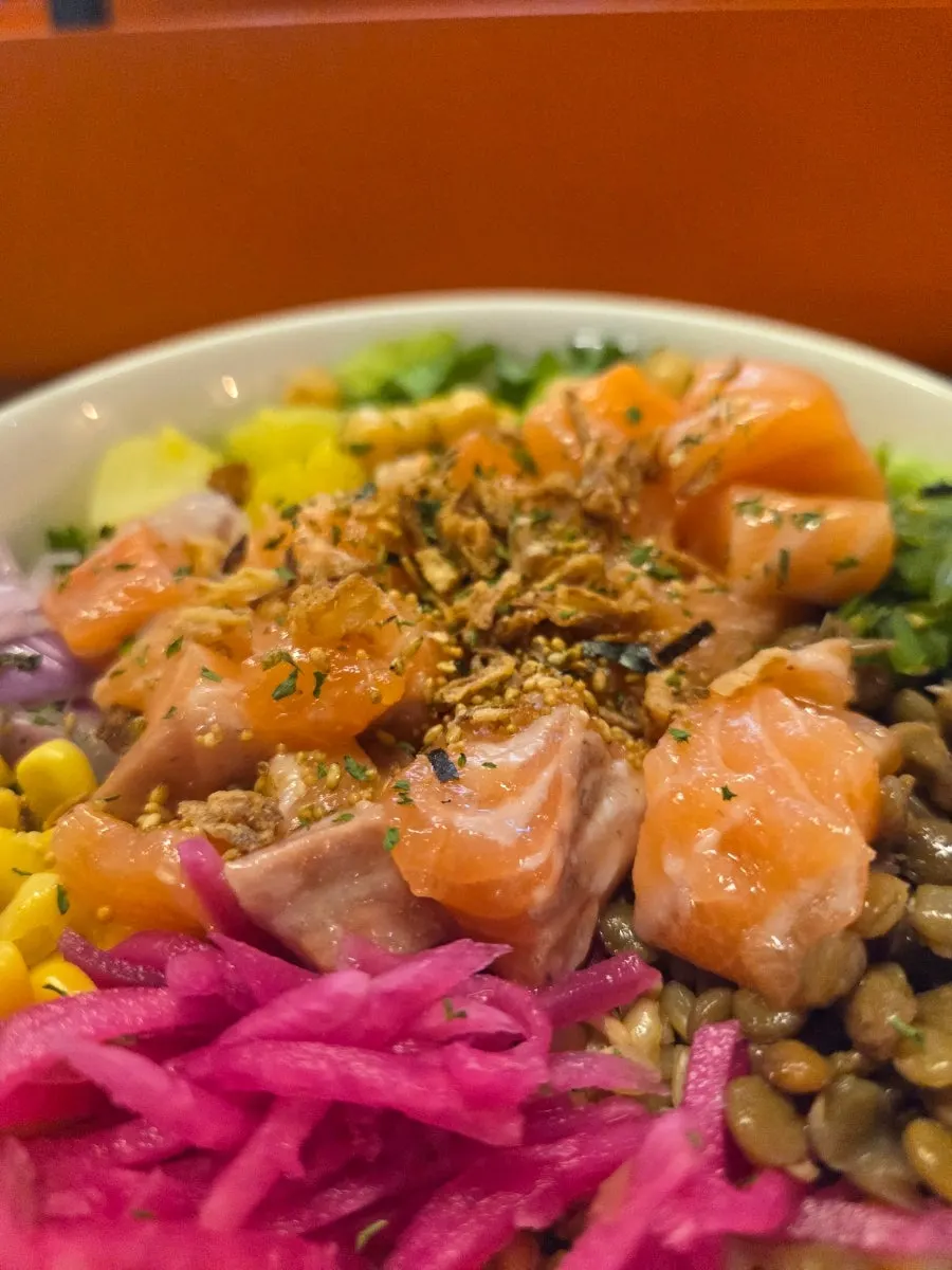 Close-up showing the thickness of the raw salmon poke's salmon