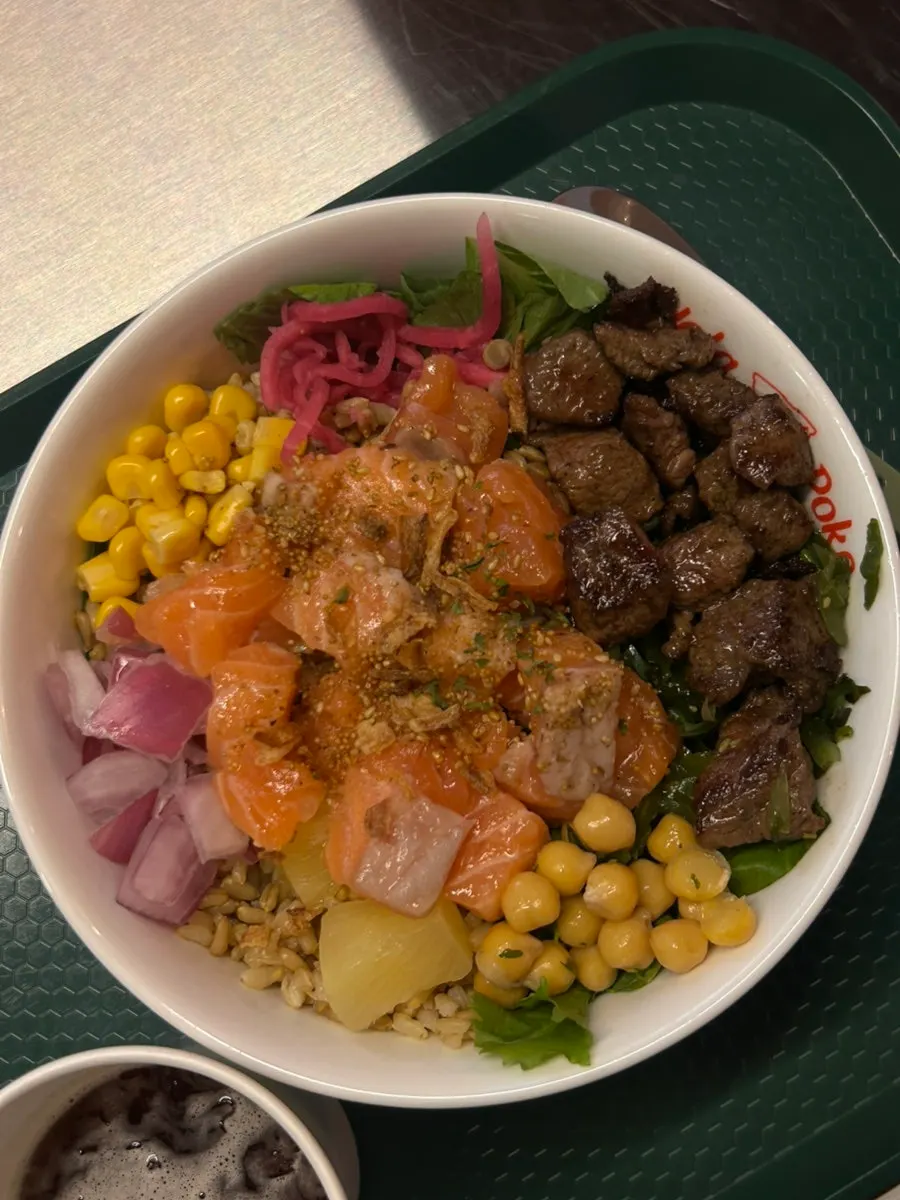 Poke bowl topped with salmon and steak