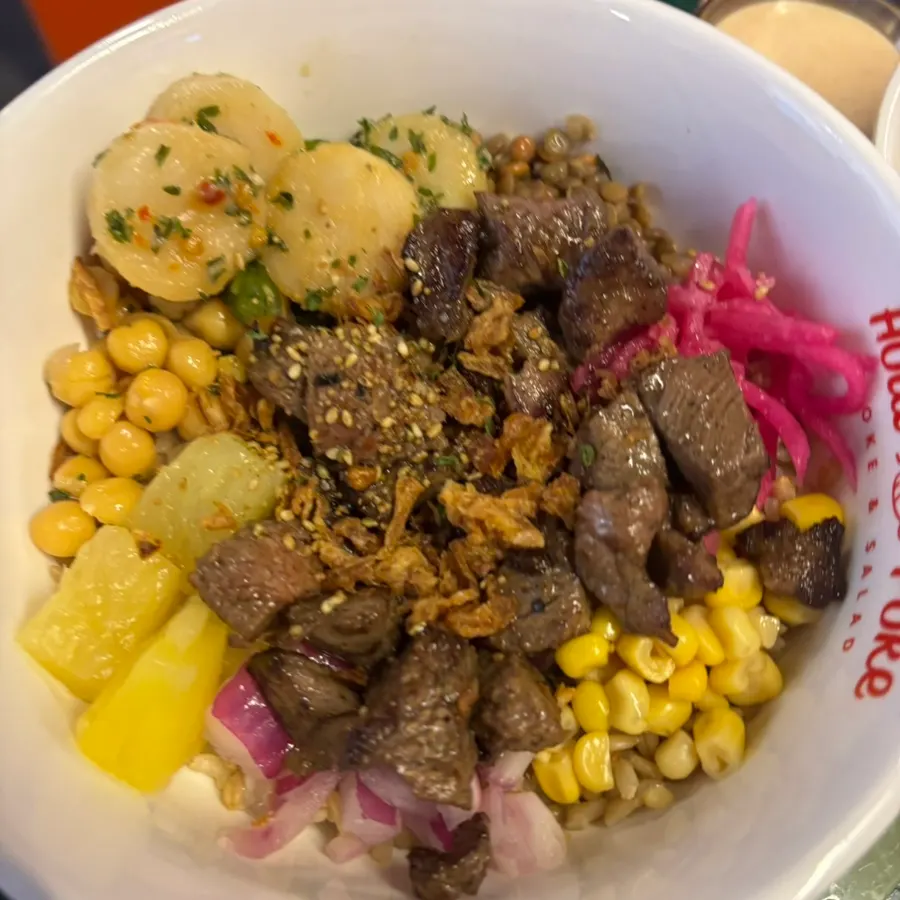 A bowl of steak poke loaded with generous toppings