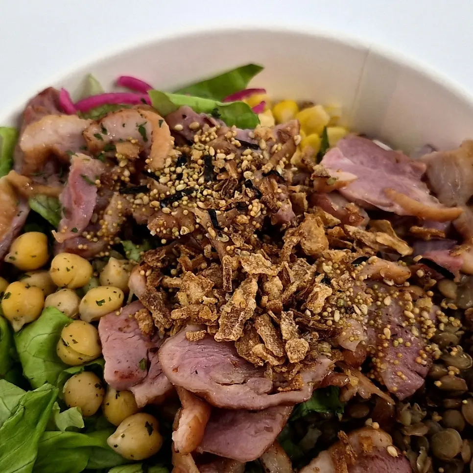 Smoked duck poke topped with chickpeas and red onion
