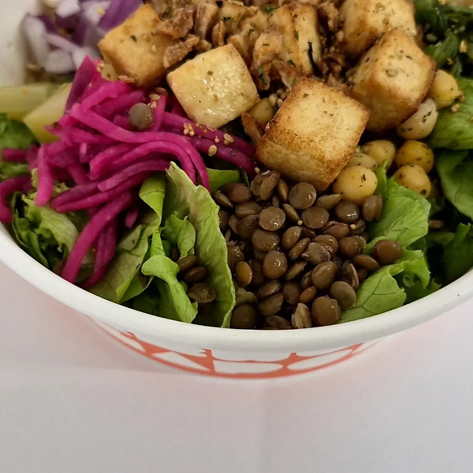 Tofu poke drizzled with black sesame sauce