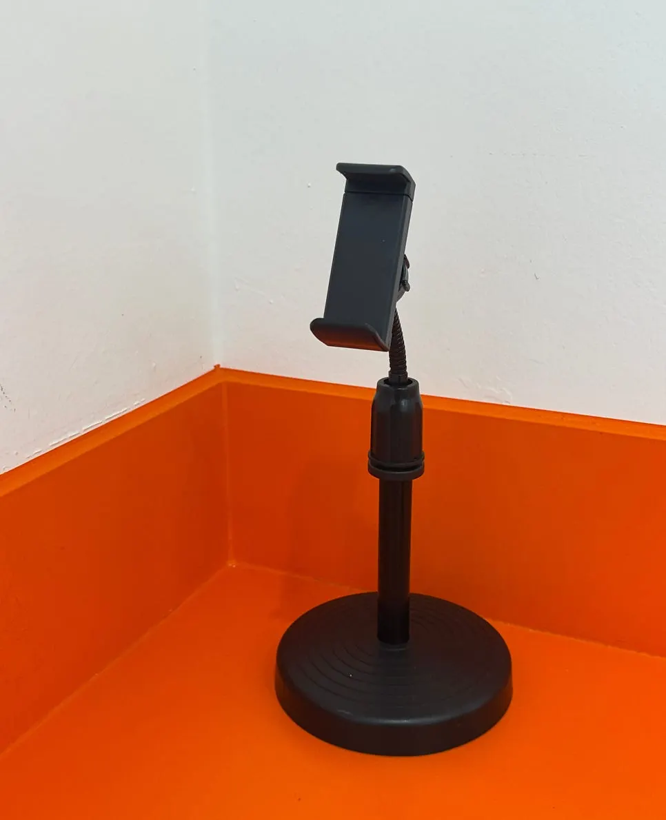 Wall-side solo seating with a phone stand