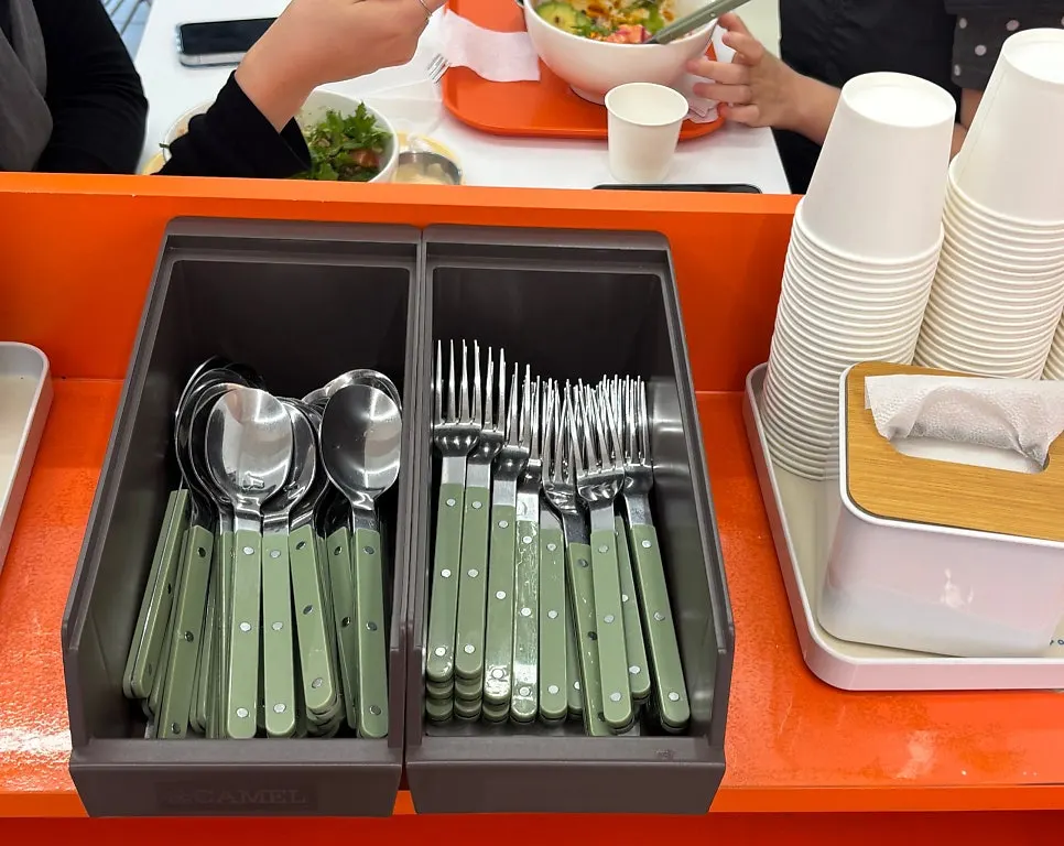 Spoons, forks, and straws at the self-serve bar