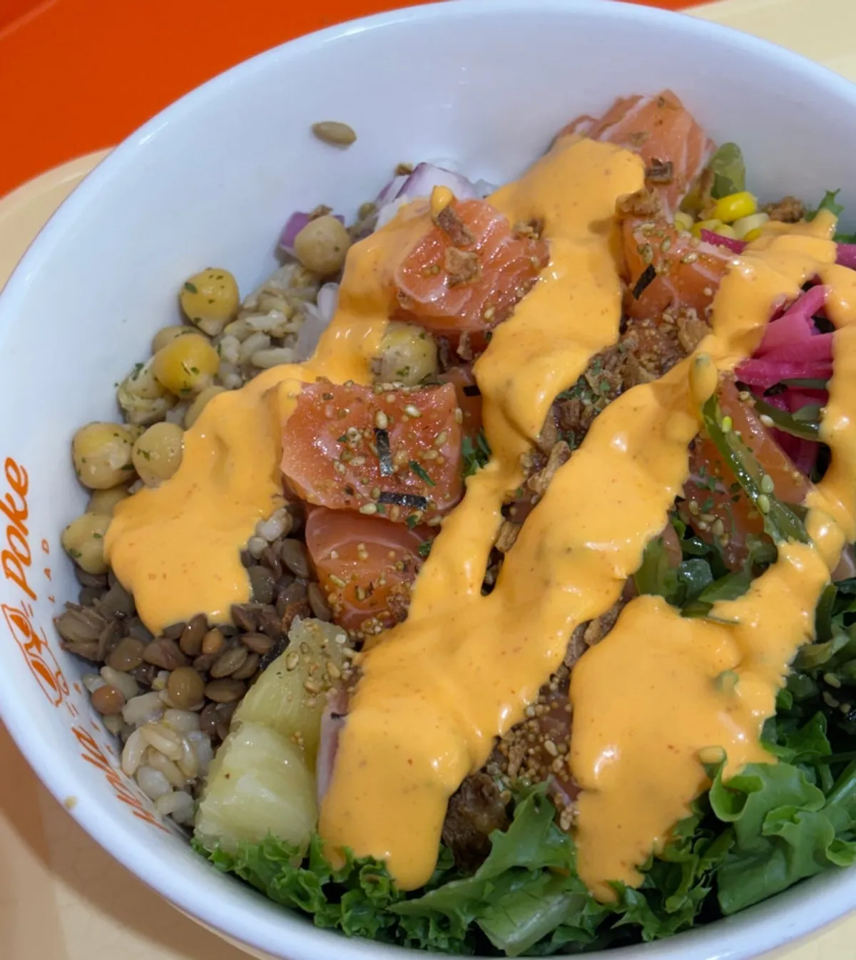 Raw salmon poke drizzled with sriracha mayo