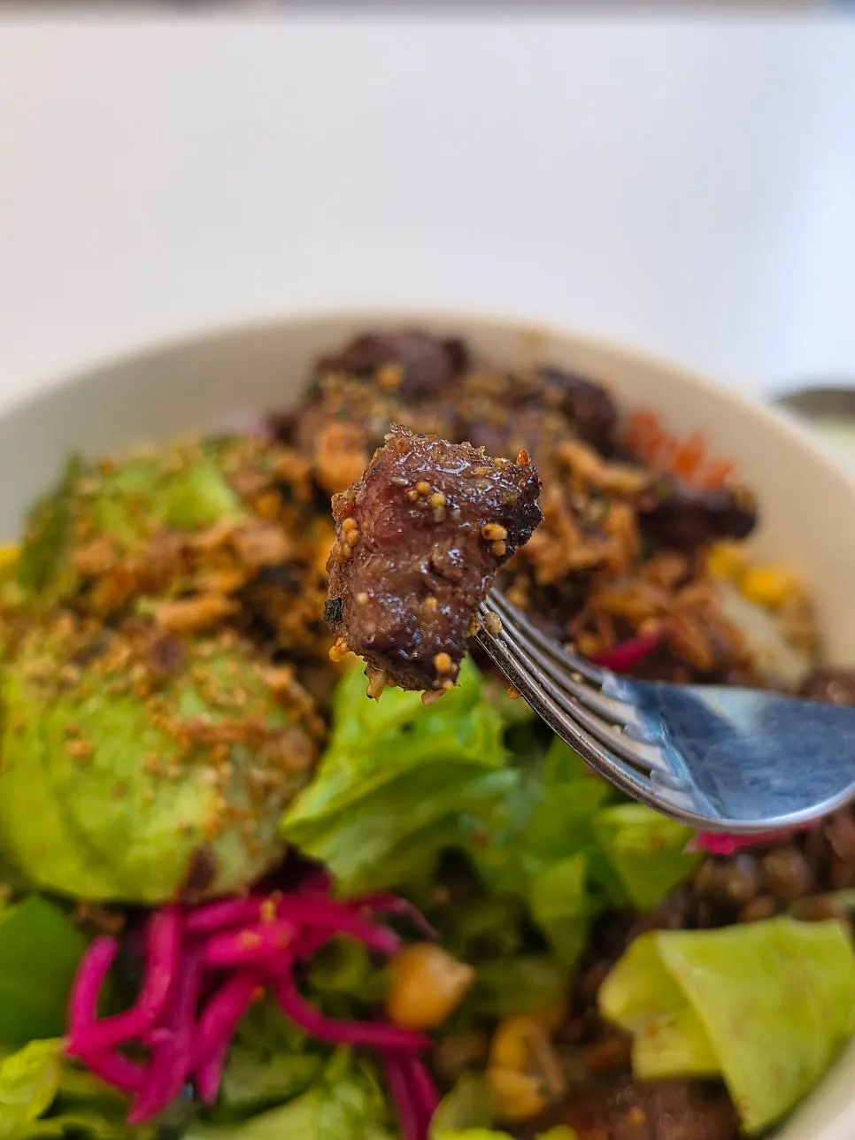 Close-up of basic toppings including red onion, corn and lentils