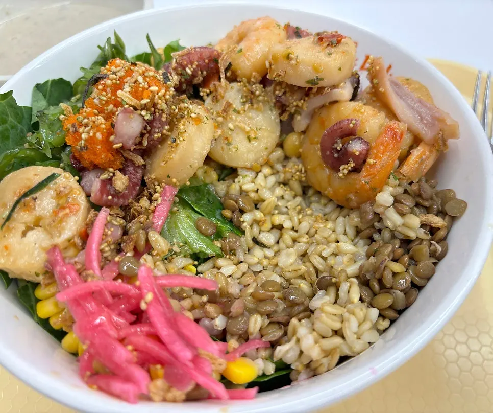 Poke bowl served with half salad, half brown rice