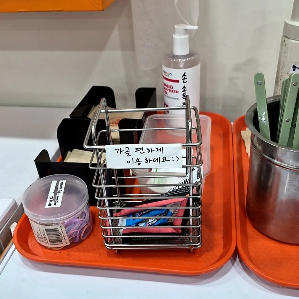 Lemon water, spoons, and cups set out at the self-serve corner