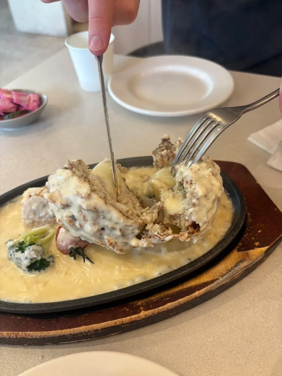 A sizzling plate of cheese cutlet