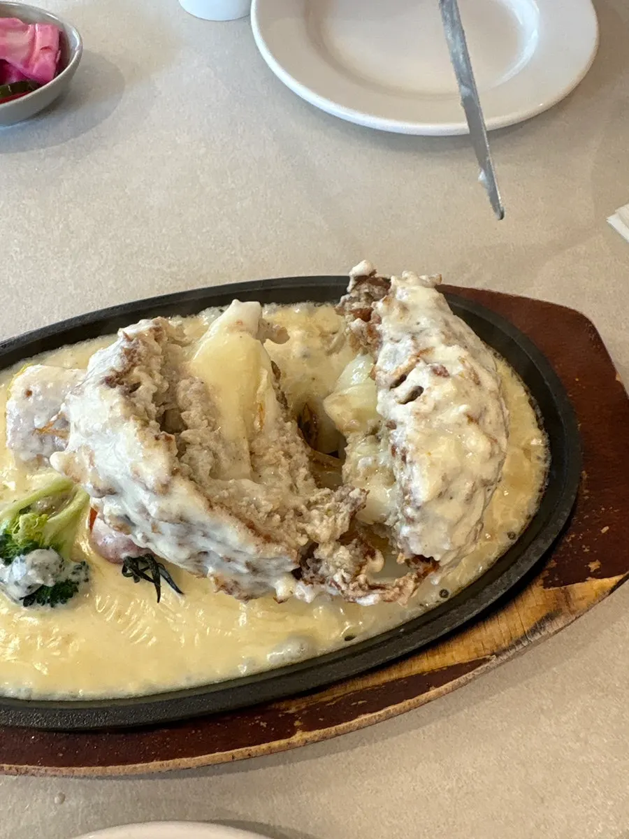 Cross-section of Omil Hongdae's cheese cutlet with stretchy cheese