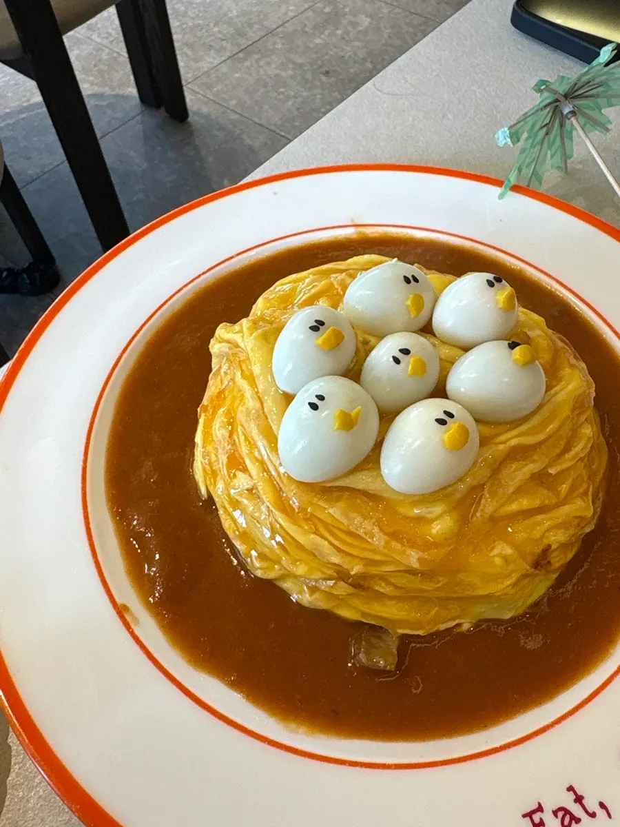 Fried rice revealed inside the fluffy egg of the omurice