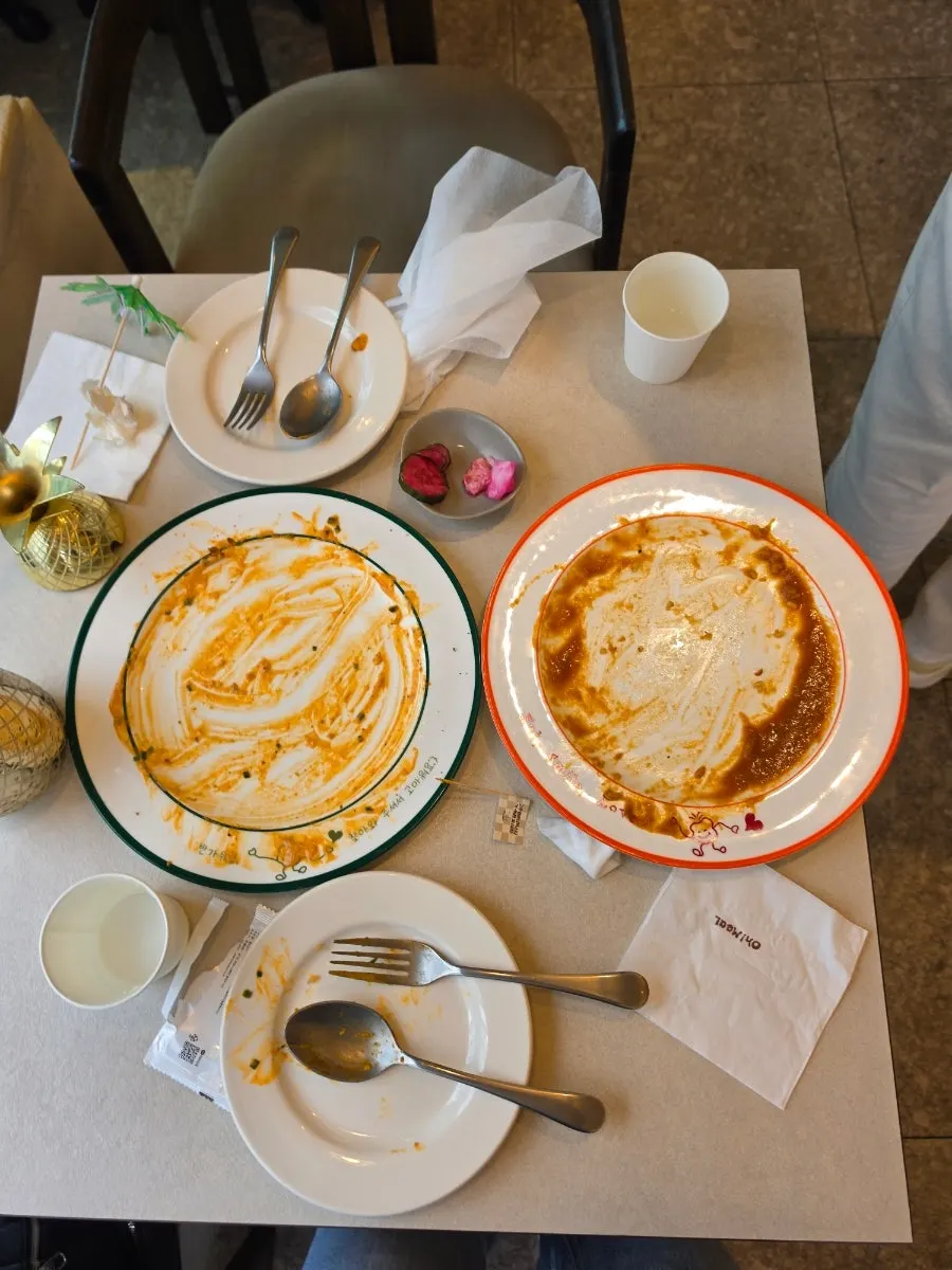Empty plate scraped clean of sauce