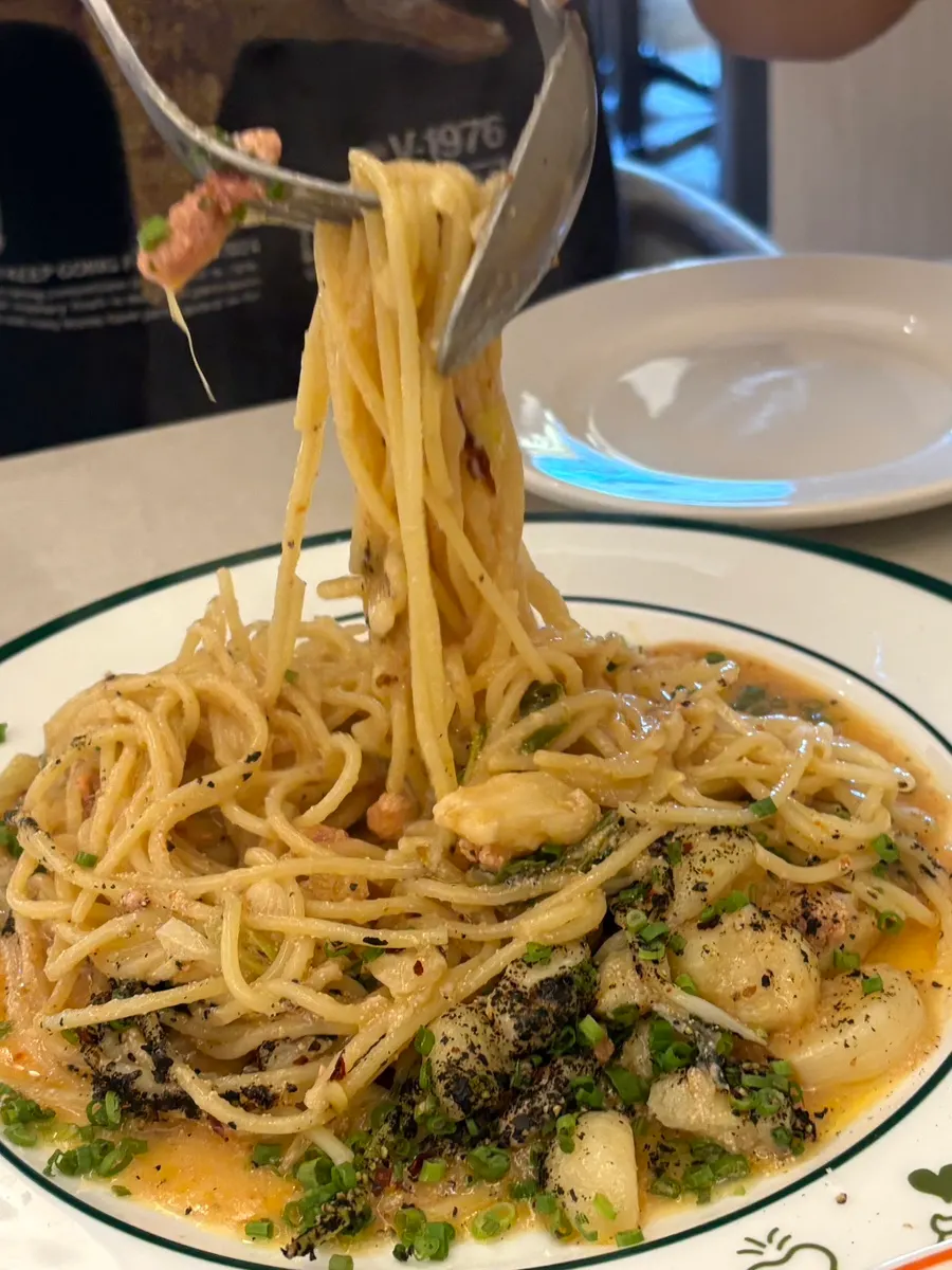 Table with both omurice and pasta dishes together