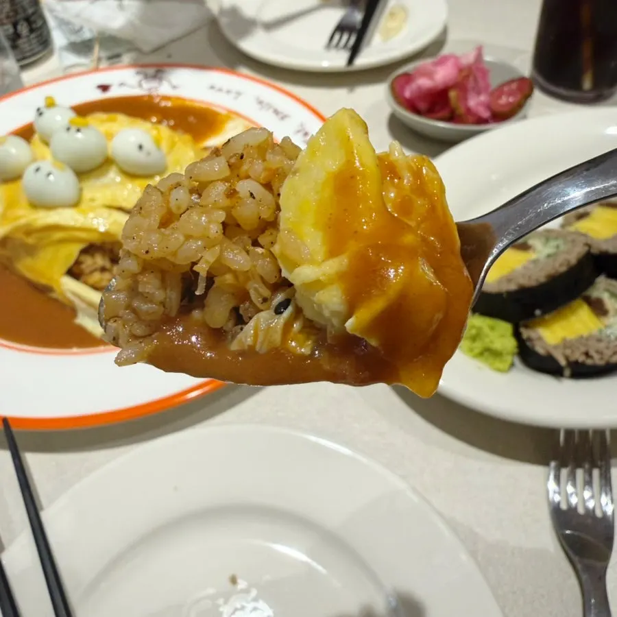 Cross-section of the omurice showing salmon fried rice inside the egg