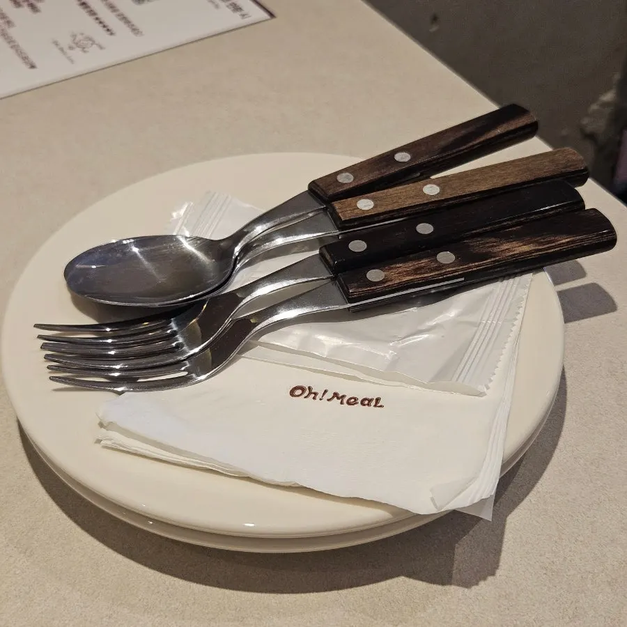 Table set with dishes, utensils and wet wipes