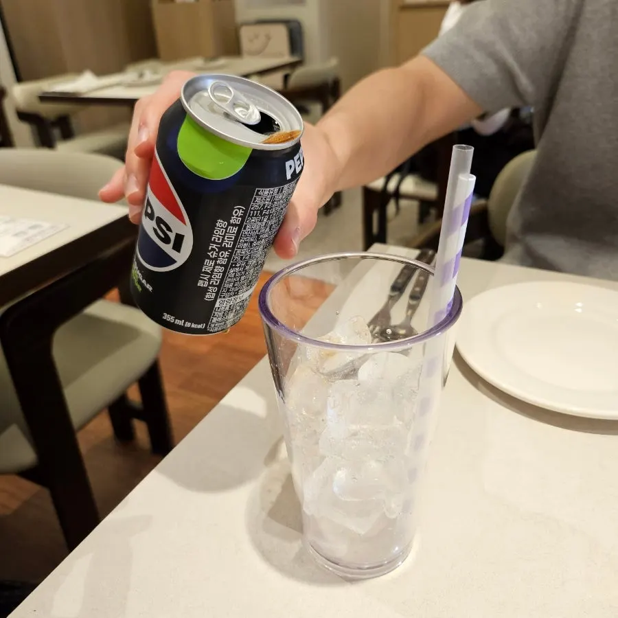 Cool glass of Coke Zero served first