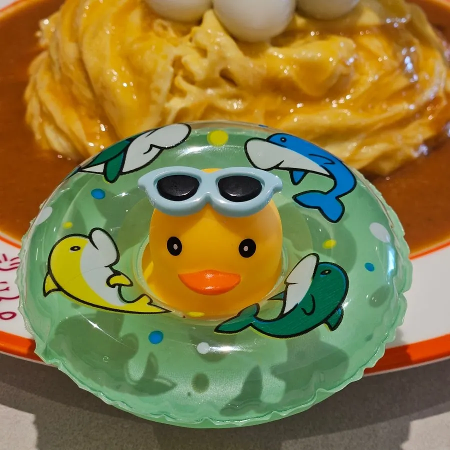 Rubber duck plush toy served alongside the omurice