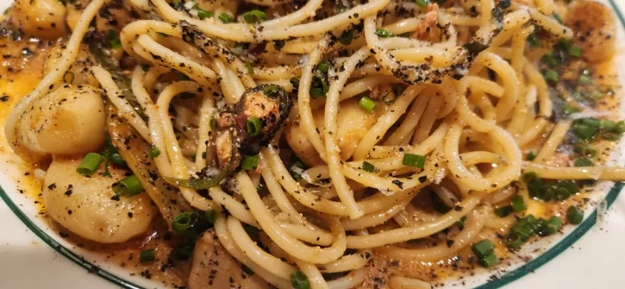 Pollack roe and pasta noodles lifted together on a fork