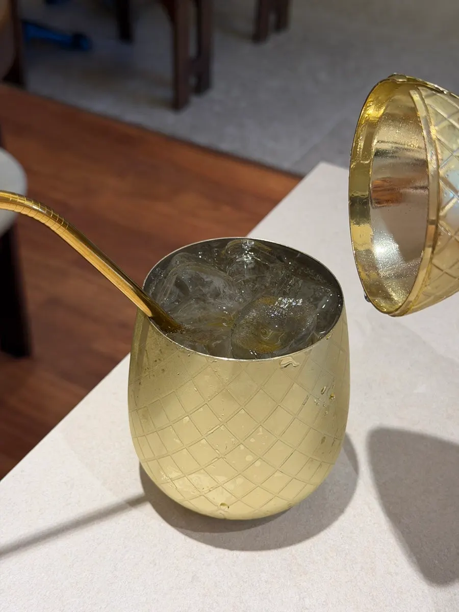 Close-up of the golden pineapple-shaped ade cup