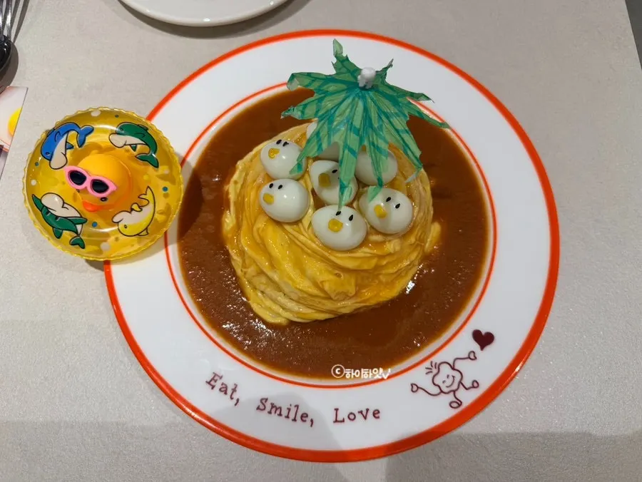Rubber duck omurice topped with a quail egg face