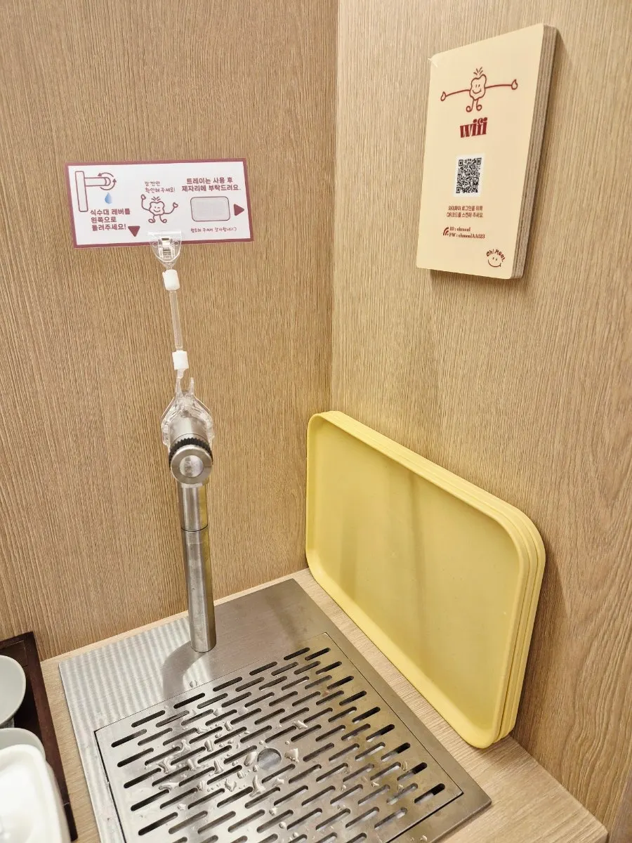 Cups and water pitcher set out at the self-service bar
