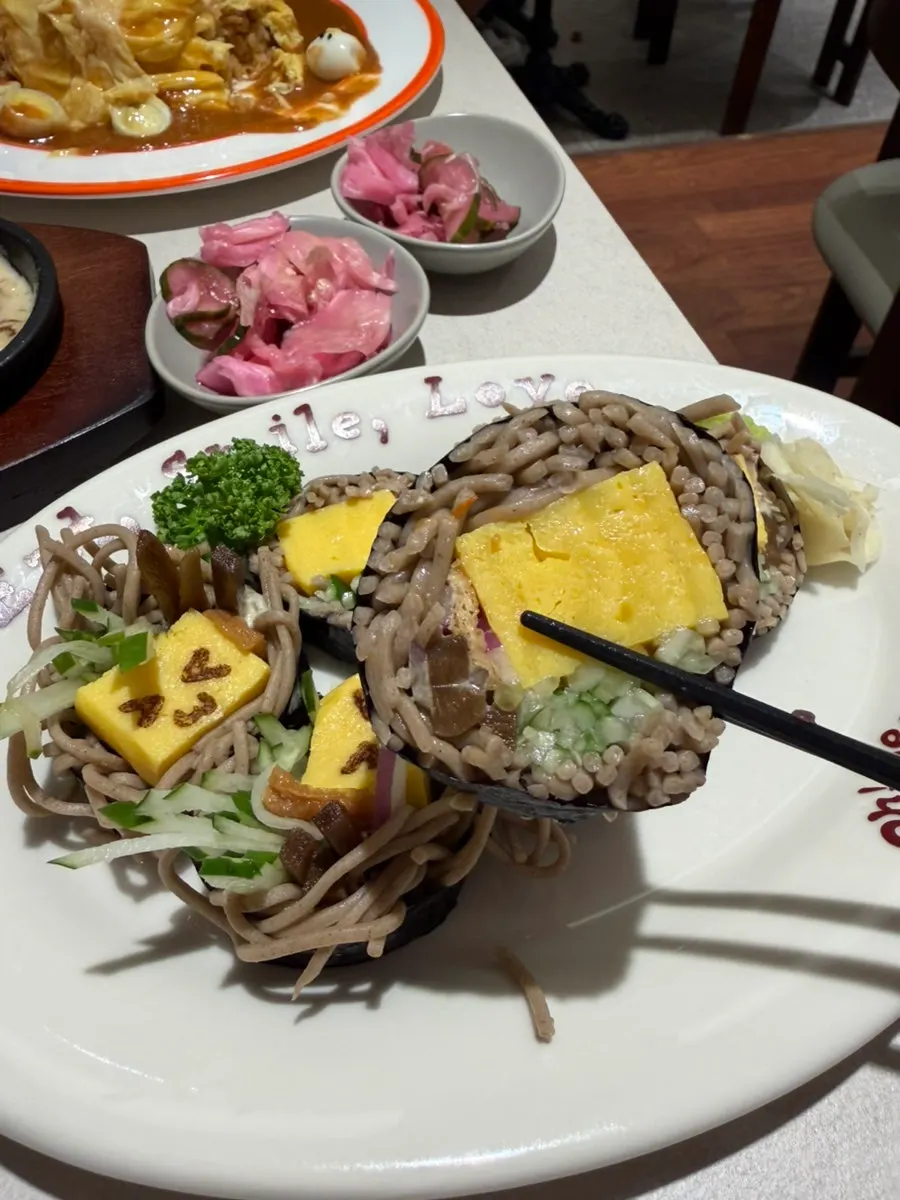 Cross-section of soba maki showing buckwheat noodles and rolled egg
