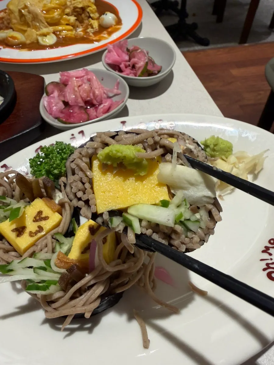 Pink self-service pickles placed on top of soba maki